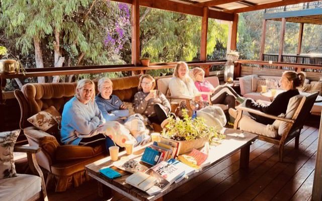 Retreat guests relaxing together on the deck at Premalaya
